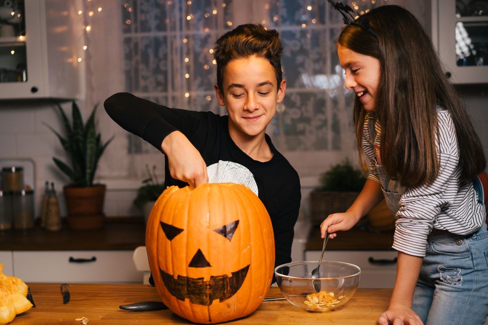 children-having-fun-carving-pumpkin-for-halloween-royalty-free-image-1693590585