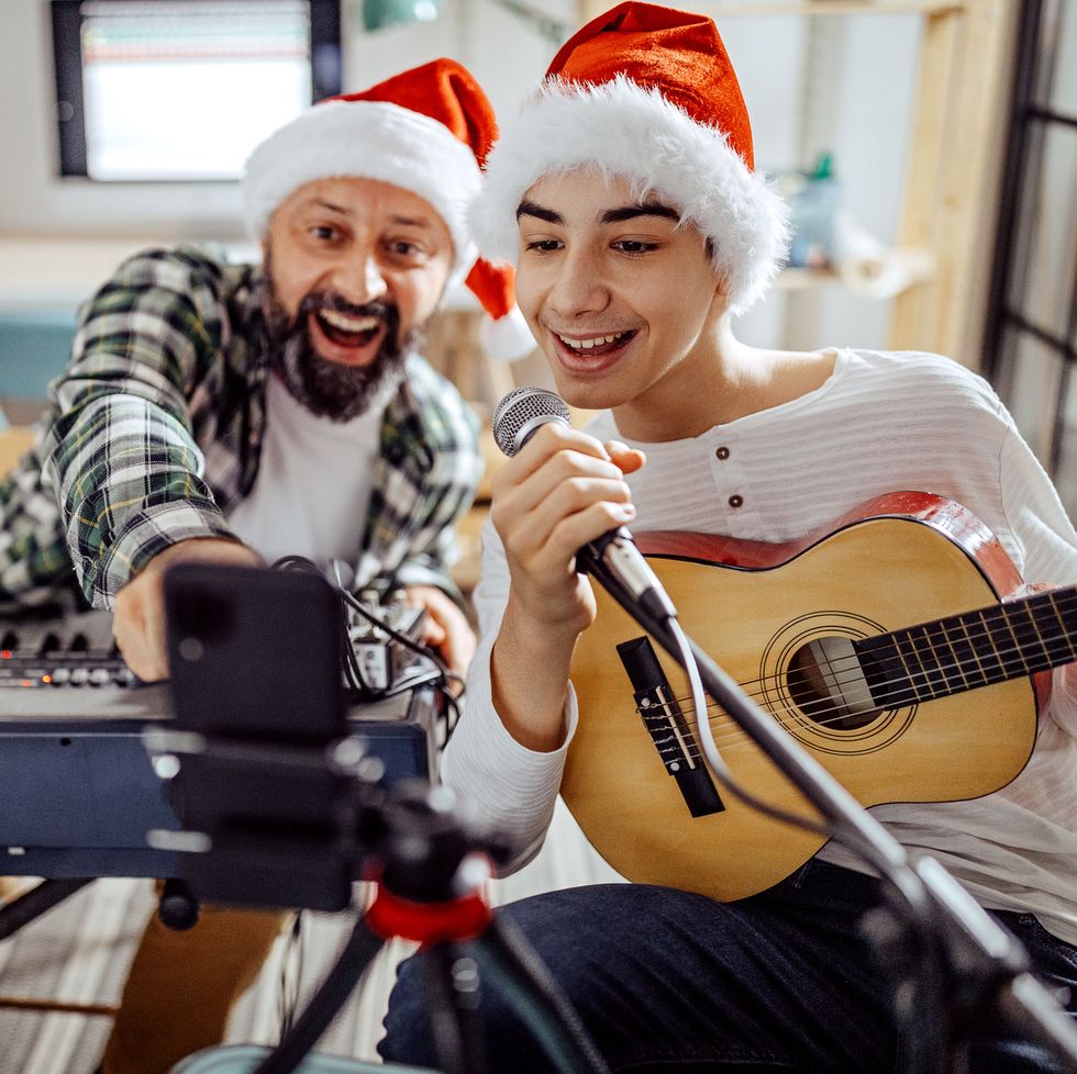 father and son have a video call with friends during the christmas holidays