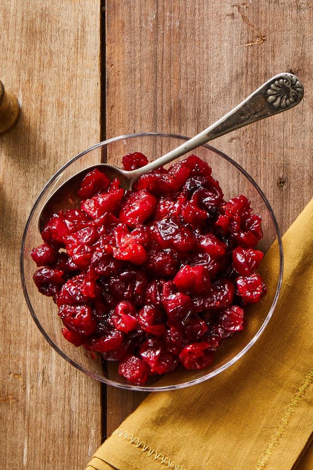 a bowl of cranberry sauce with spoon