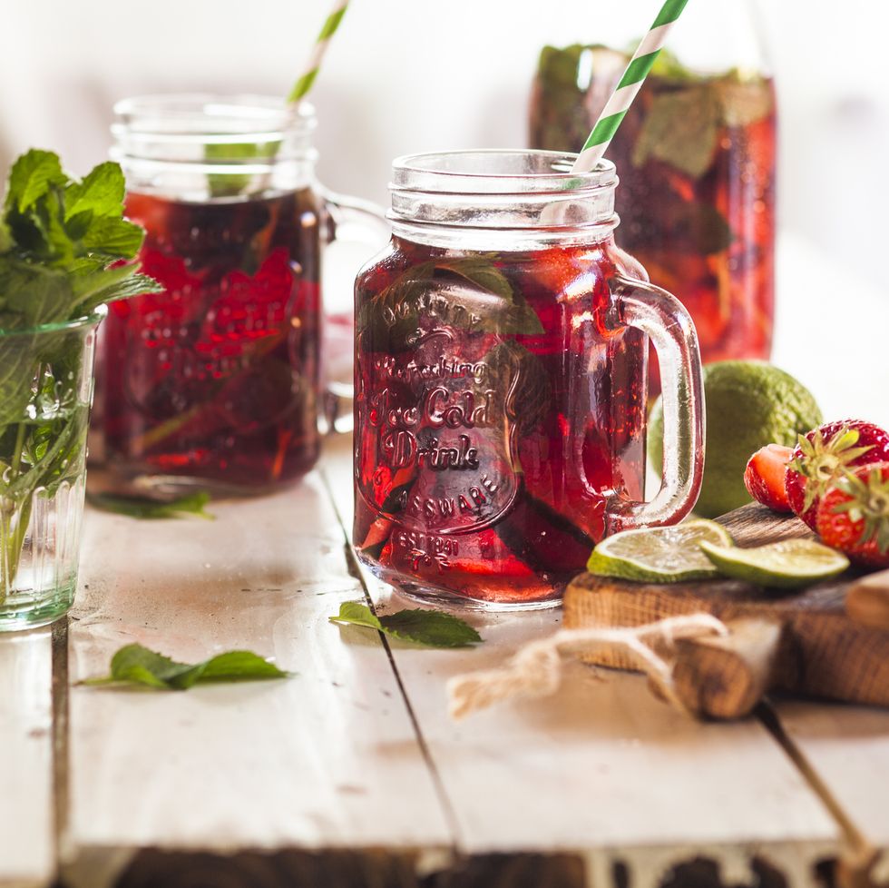 iced tea with fruits, hibiscus, strawberries, mint, limes