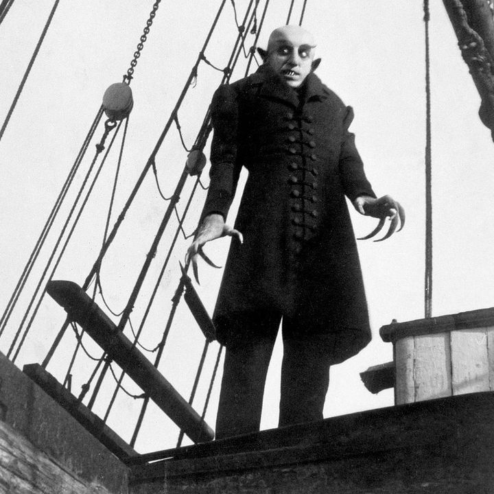 a vampirelike creature stands on the deck of a ship ini a scene from nosferatu, a good housekeeping pick for best halloween movies