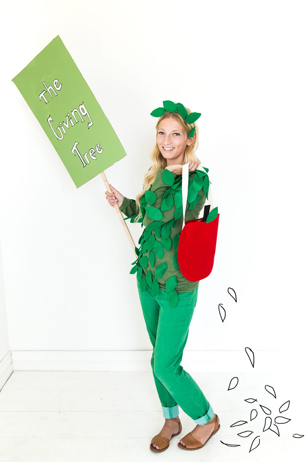 woman dressed in green and red as the giving tree