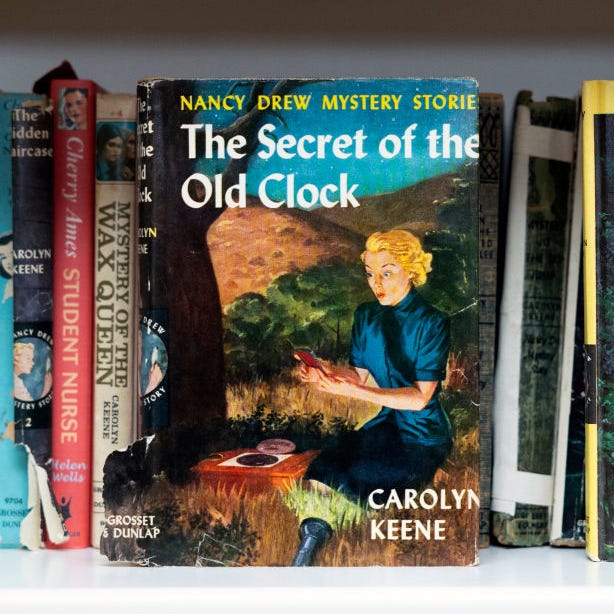 nancy drew book's the secret of the old clock and the mystery at lilac inn sitting on a library shelf