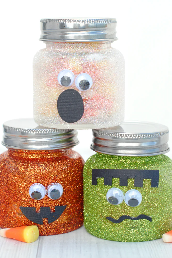 a couple of jars with halloween faces