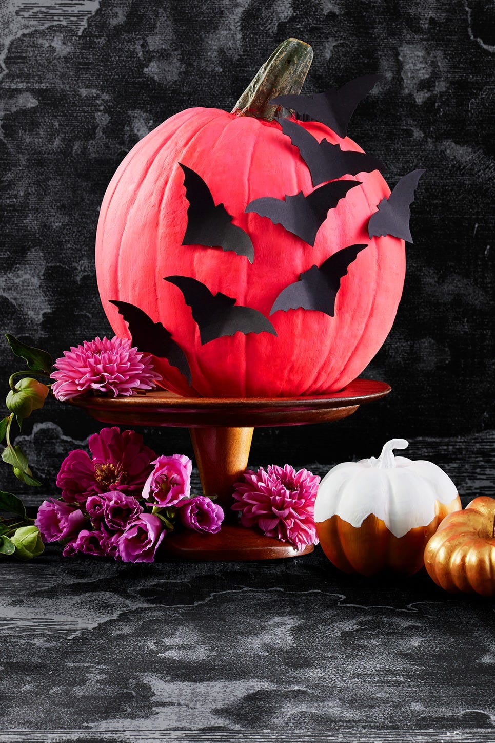 halloween crafts, large pink pumpkin with paper bats attached to it