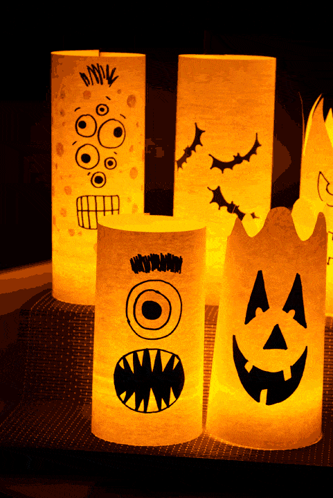 halloween crafts, paper luminaries with drawn on monster faces