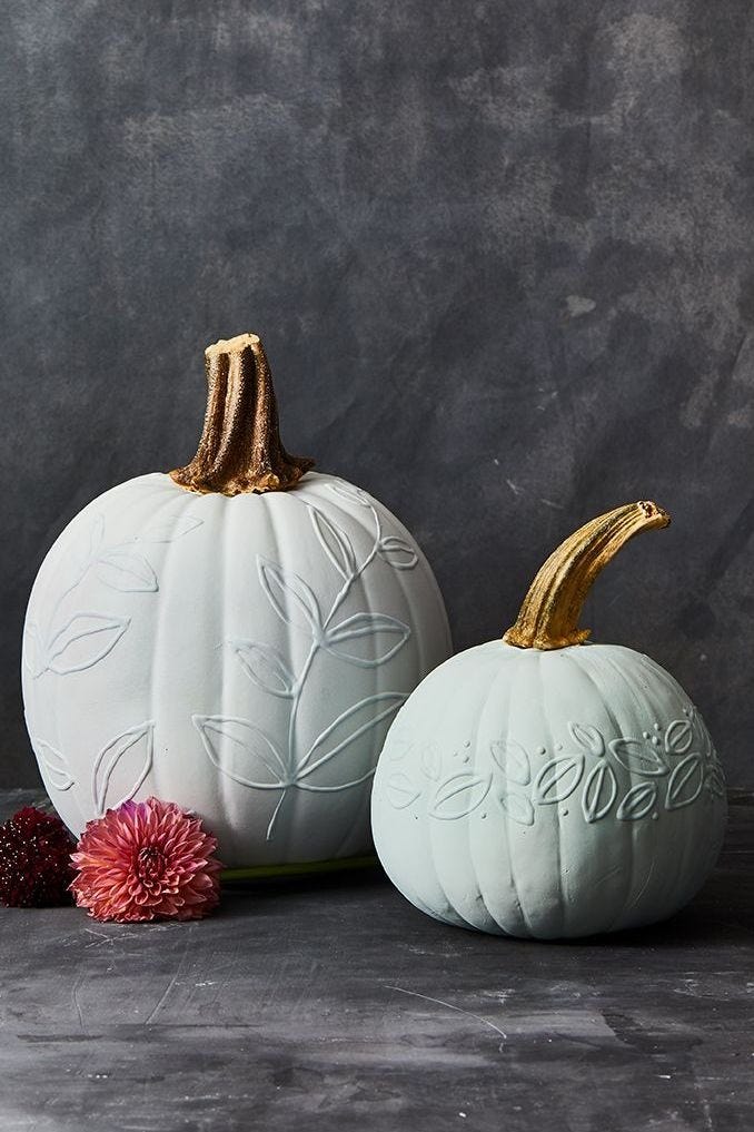 halloween crafts, two white 3d painted pumpkins with leaf designs