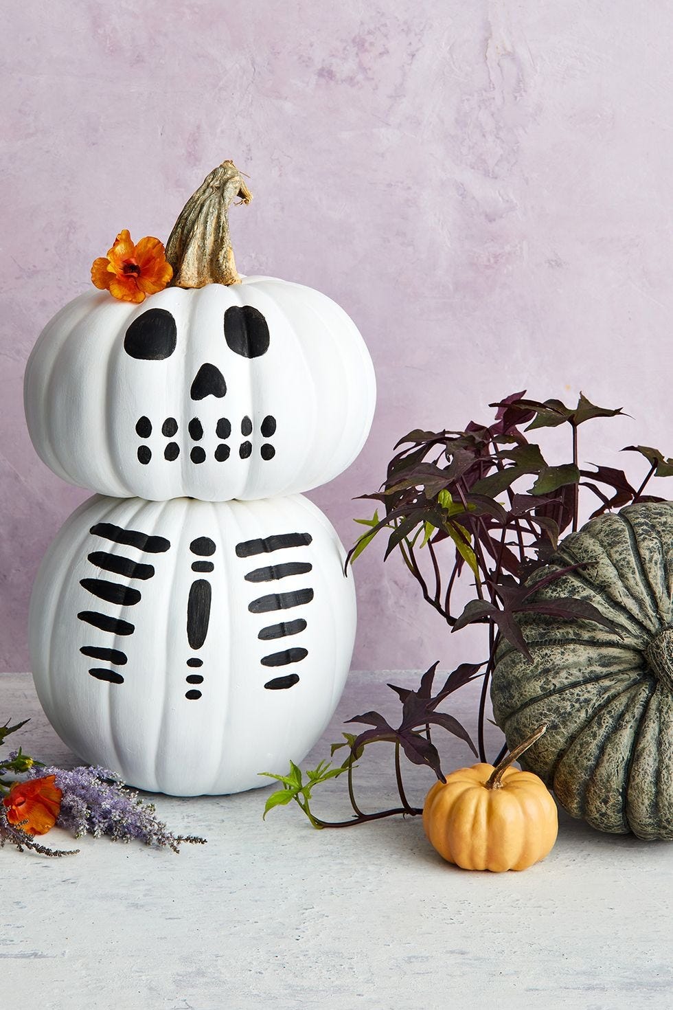 halloween crafts, two white pumpkin stacked on top of each other to look like a skeleton