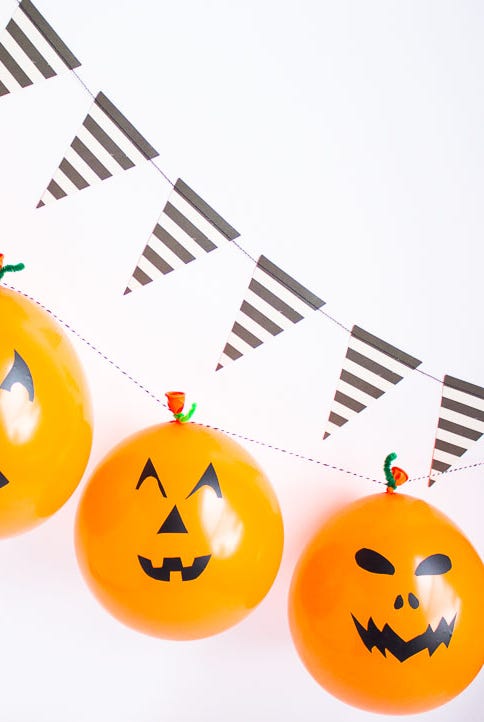 a group of orange and black pumpkins with faces drawn on them