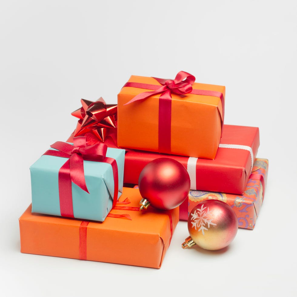 a pile of christmas presents wrapped in blue orange and red