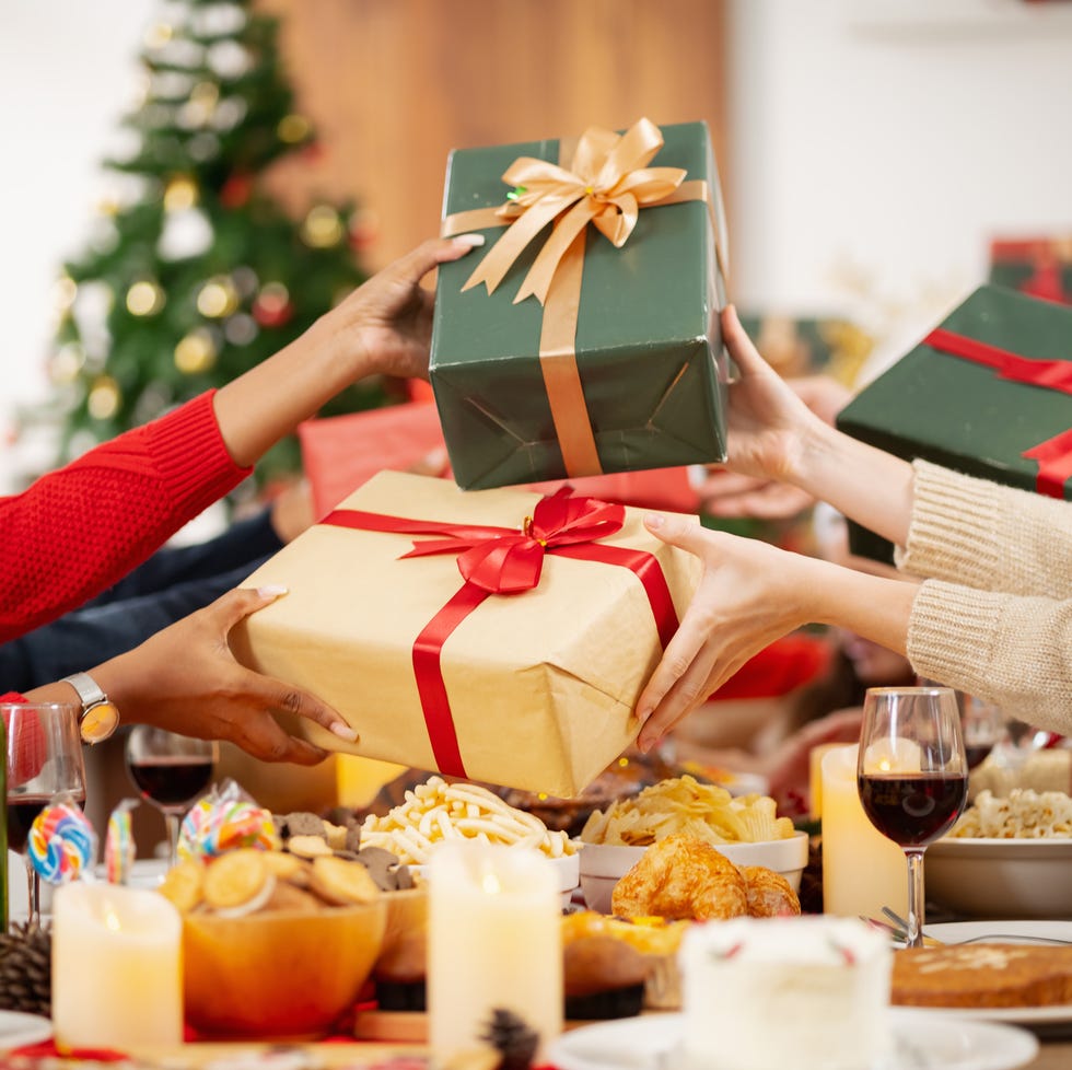 a group of adults exchanging wrapped christmas presents