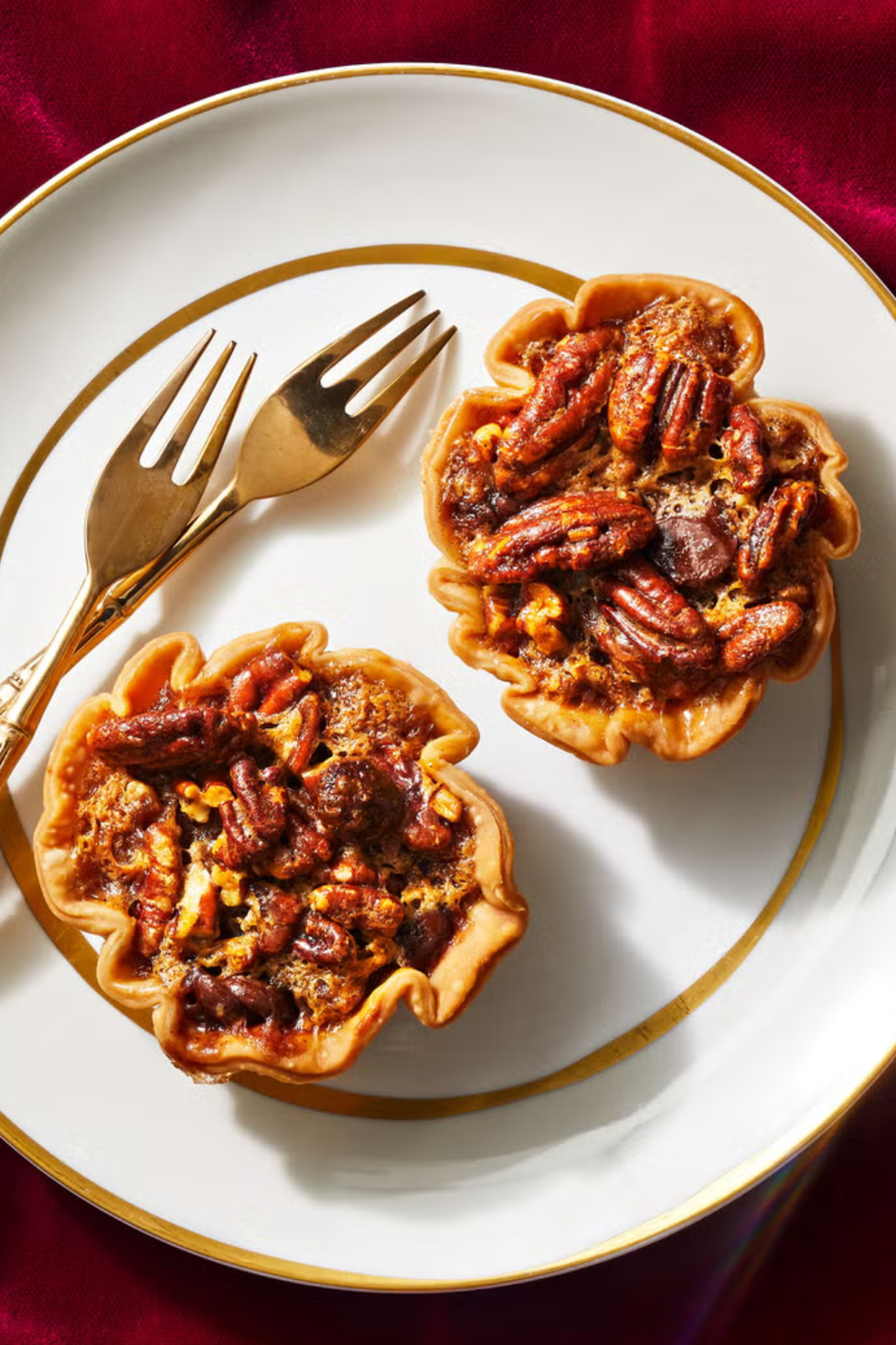 mini chocolate pecan pies on a white plate