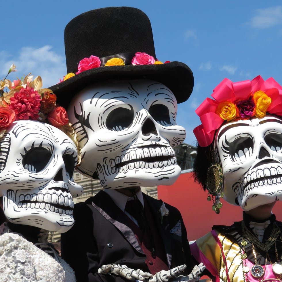 participants of the mexican holiday in death masks