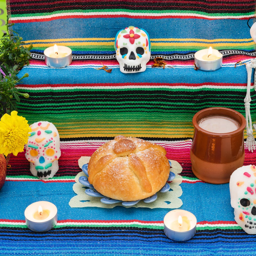 altar decorated with pan de muerto and skulls day of the dead mexican holiday