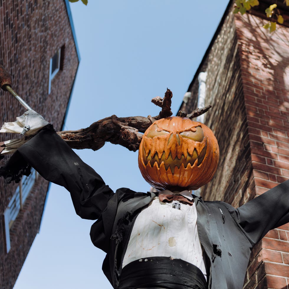 low angle view of pumpkin scarecrow halloween decor outside of townhouse