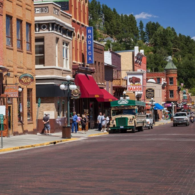 tourist explore main street in historic deadwood, south dakota