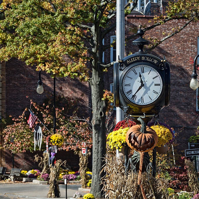 sleepy hollow, new york town clock with autumn decorations