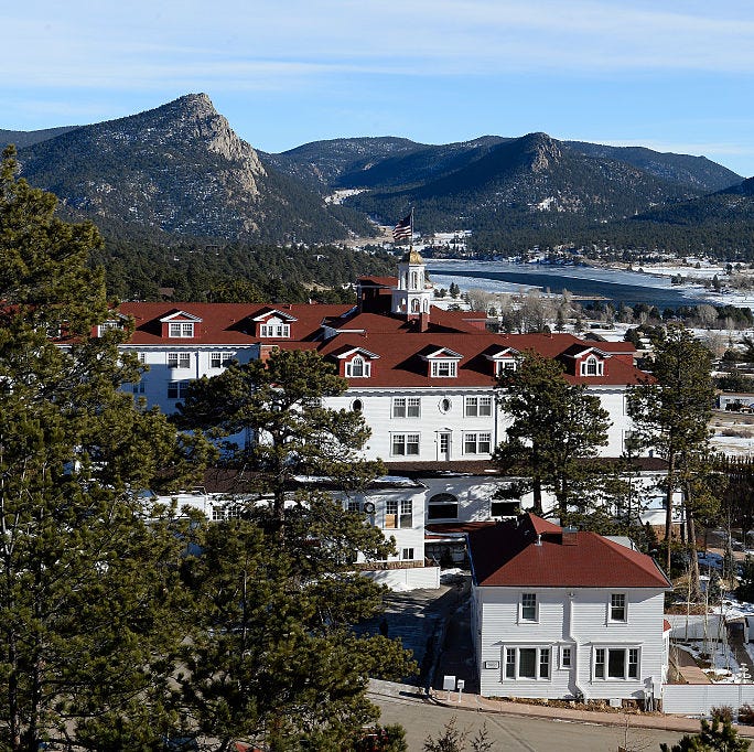 the stanley hotel is pictured from high above in estes park, colorado