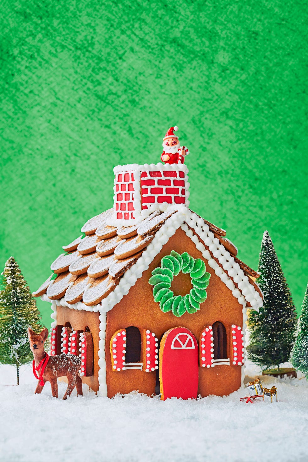 gingerbread cottage against a green background