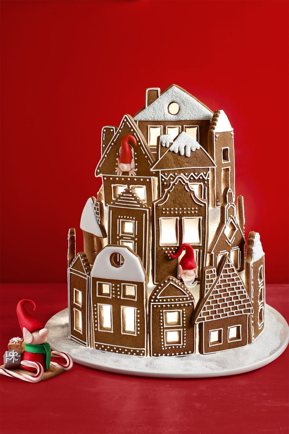 a giant gingerbread village set against a red background