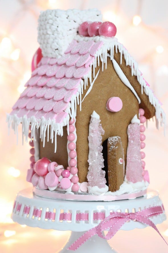 a gingerbread house decorated in pink candy