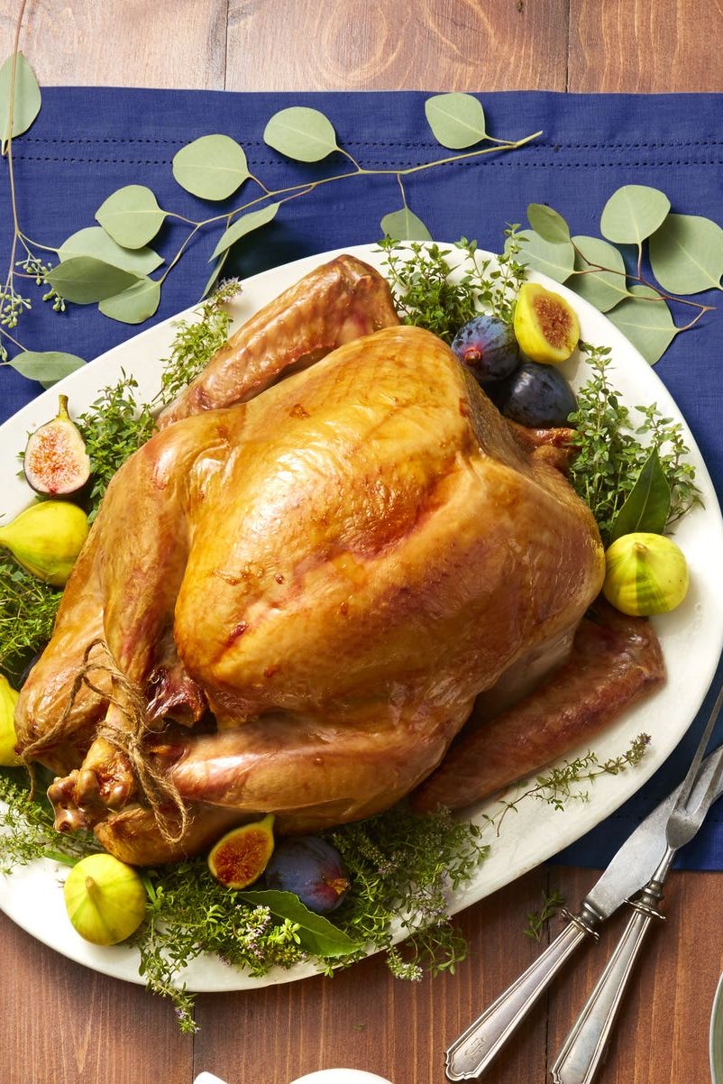 roasted turkey on a platter with fruits