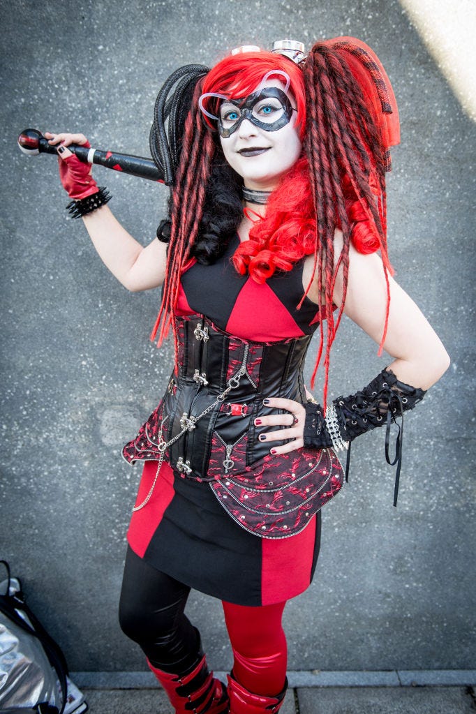 woman wearing a black and red outfit with black and red hair