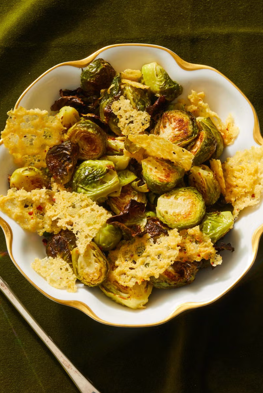 roasted brussels sprouts with parmesan crisps in a white bowl