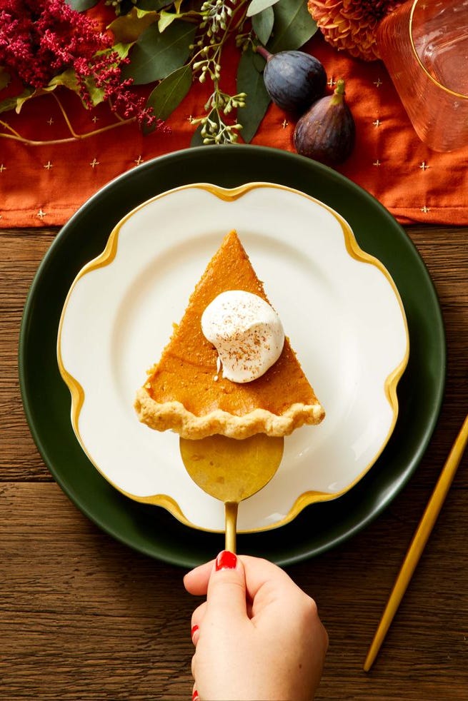 a slice of spiced pumpkin pie with whipped cream on top