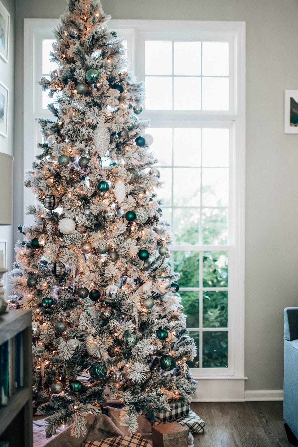 a christmas tree with dark green and black and white ornaments