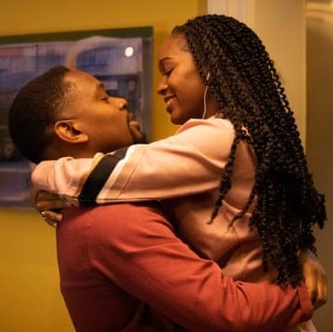 a man and woman hug in a scene from boxing day