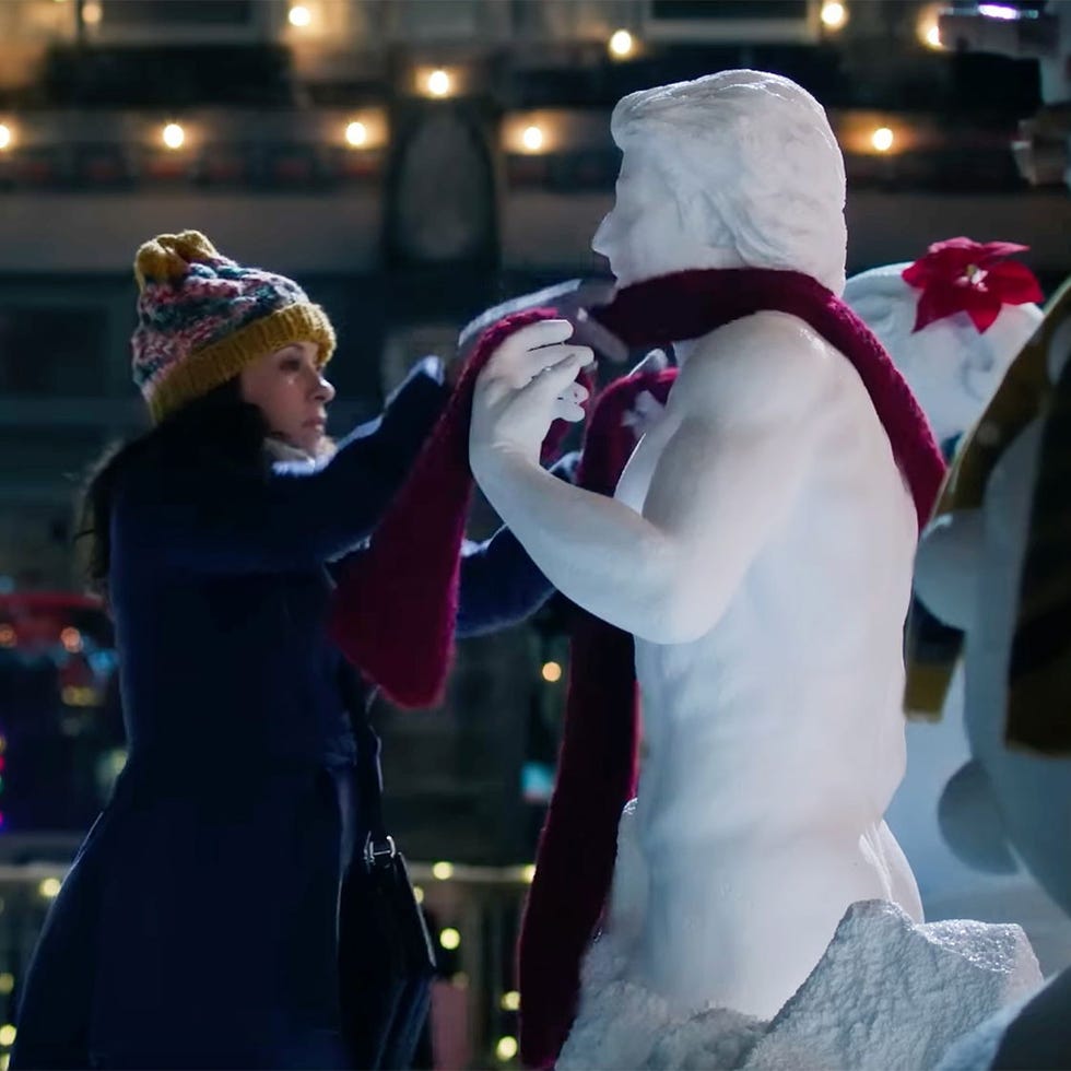 a woman puts a magic scarf on a chiseled ice sculpture in a scene from hot frosty, which is an actual movie that exists