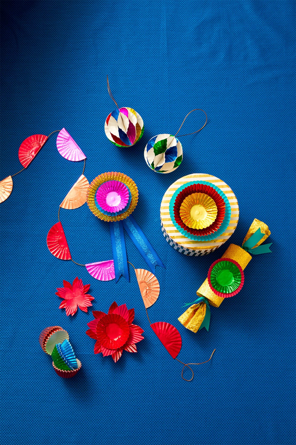 colorful decorative paper crafts arranged on a blue surface