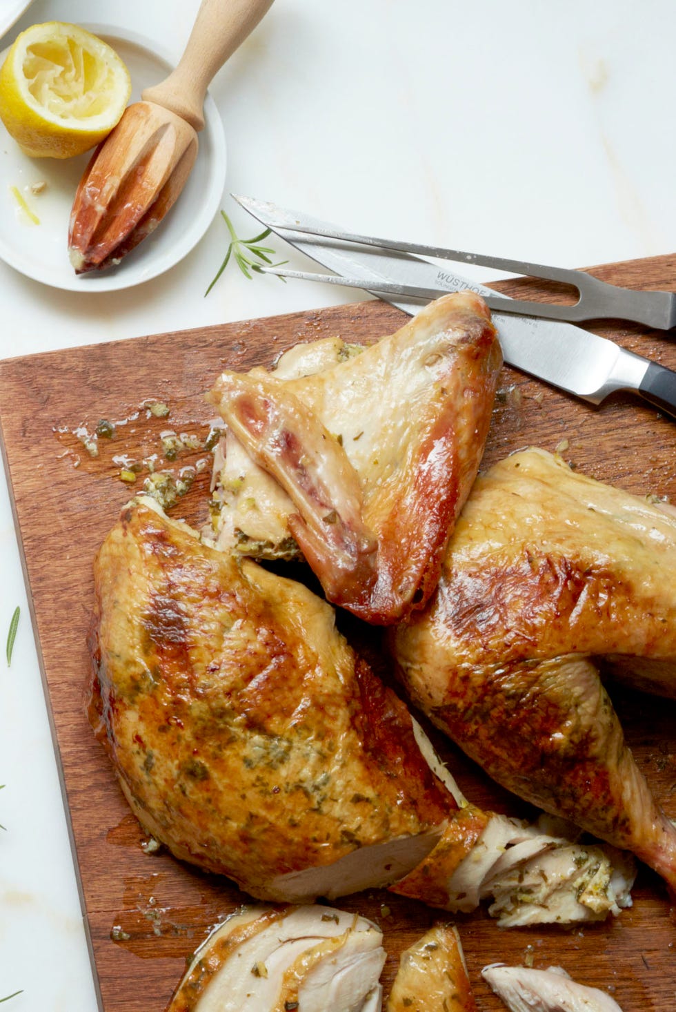 herb and lemon stuffed turkey on a butcher board