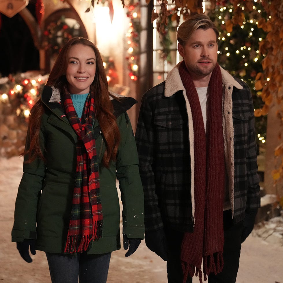 lindsay lohan as sierra and chord overstreet as jake in a scene from falling for christmas, a good housekeeping pick for best romantic christmas movies