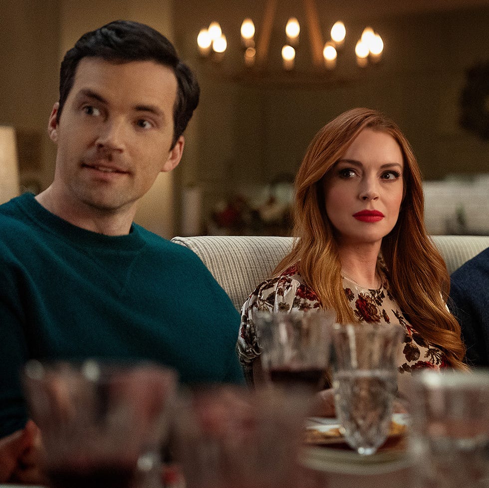 ian harding as logan, lindsay lohan as avery and jon rudnitsky as cameron sit awkwardly around a dinner table in a scene from our little secret