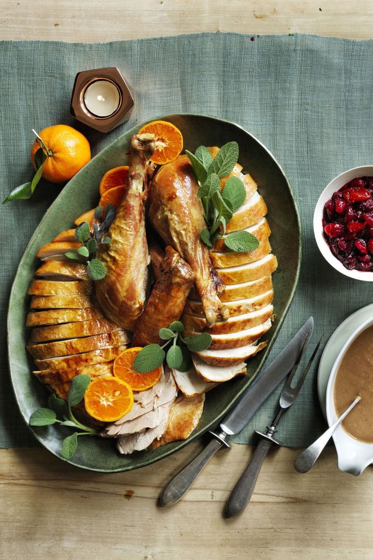 sage and orange roast turkey sliced on a serving platter