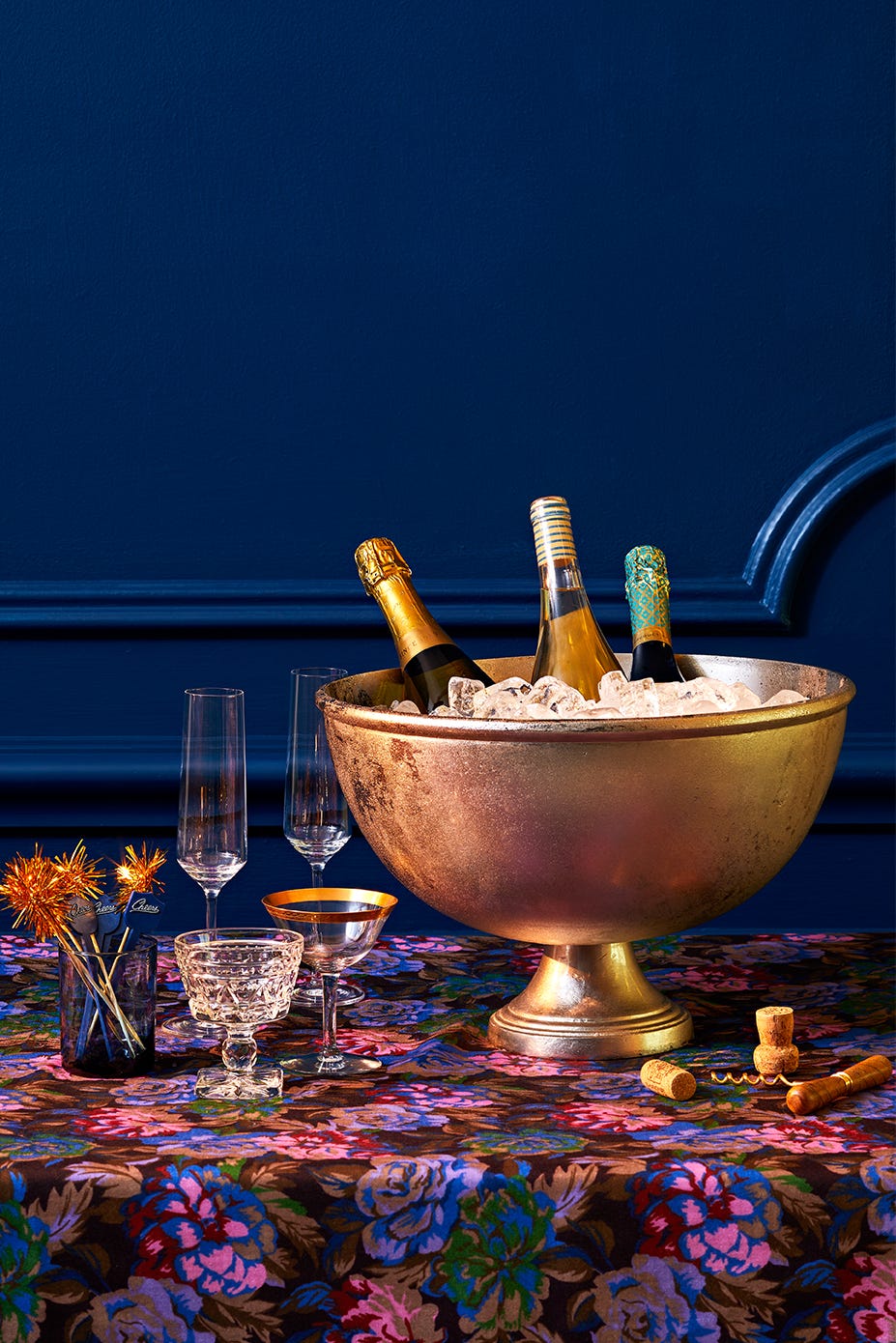 a festive table setting with champagne bottles glasses and decorative elements