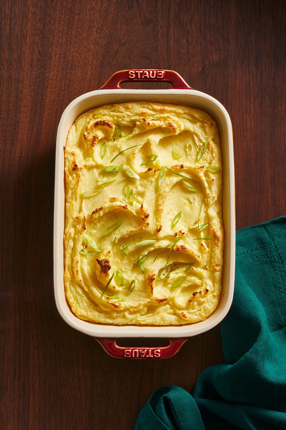 baked dish of creamy mashed potatoes topped with green onions