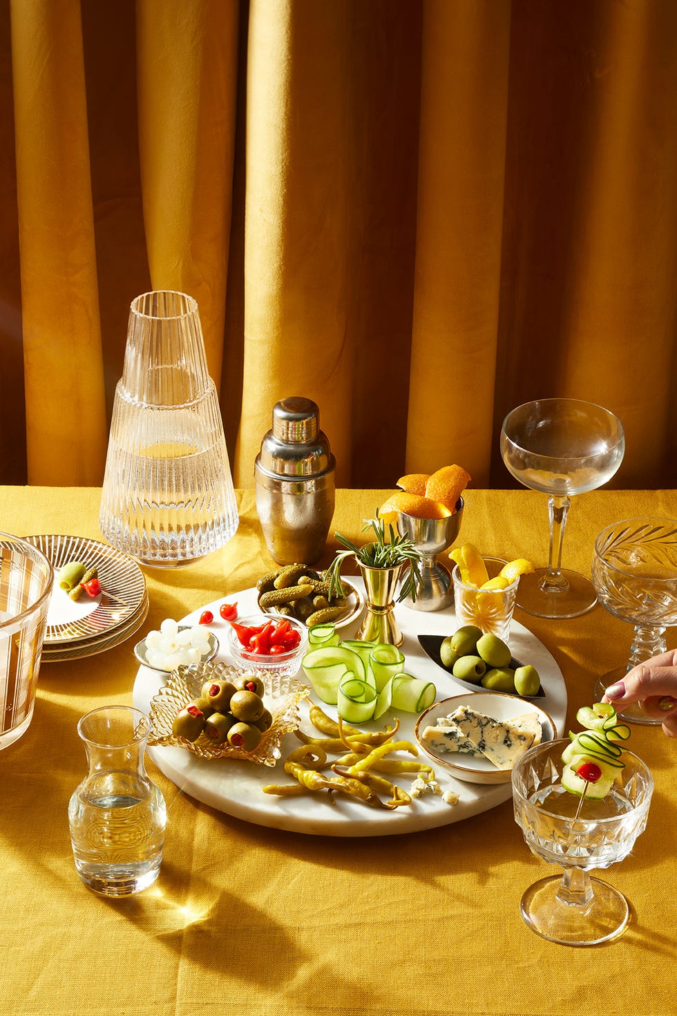 garnish and cocktail preparation setup on a yellow tablecloth