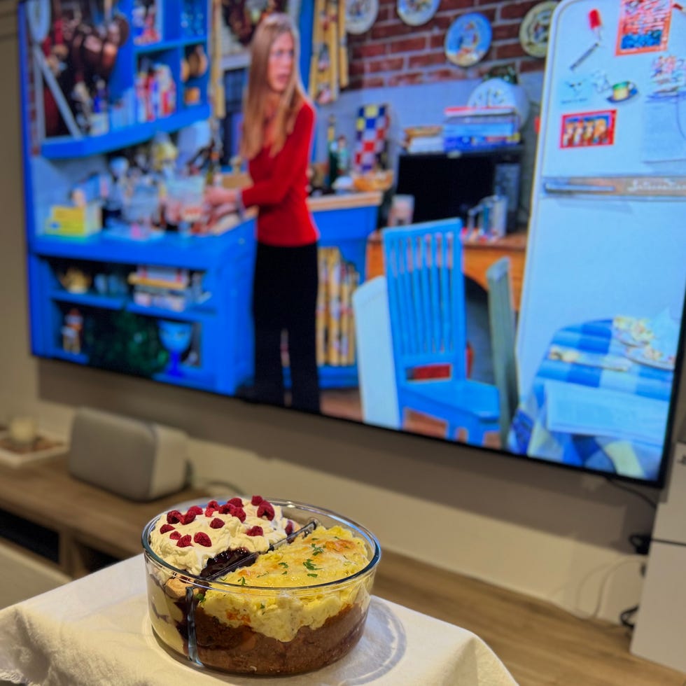 dessert placed on a table in a living room with a tv showing a kitchen scene