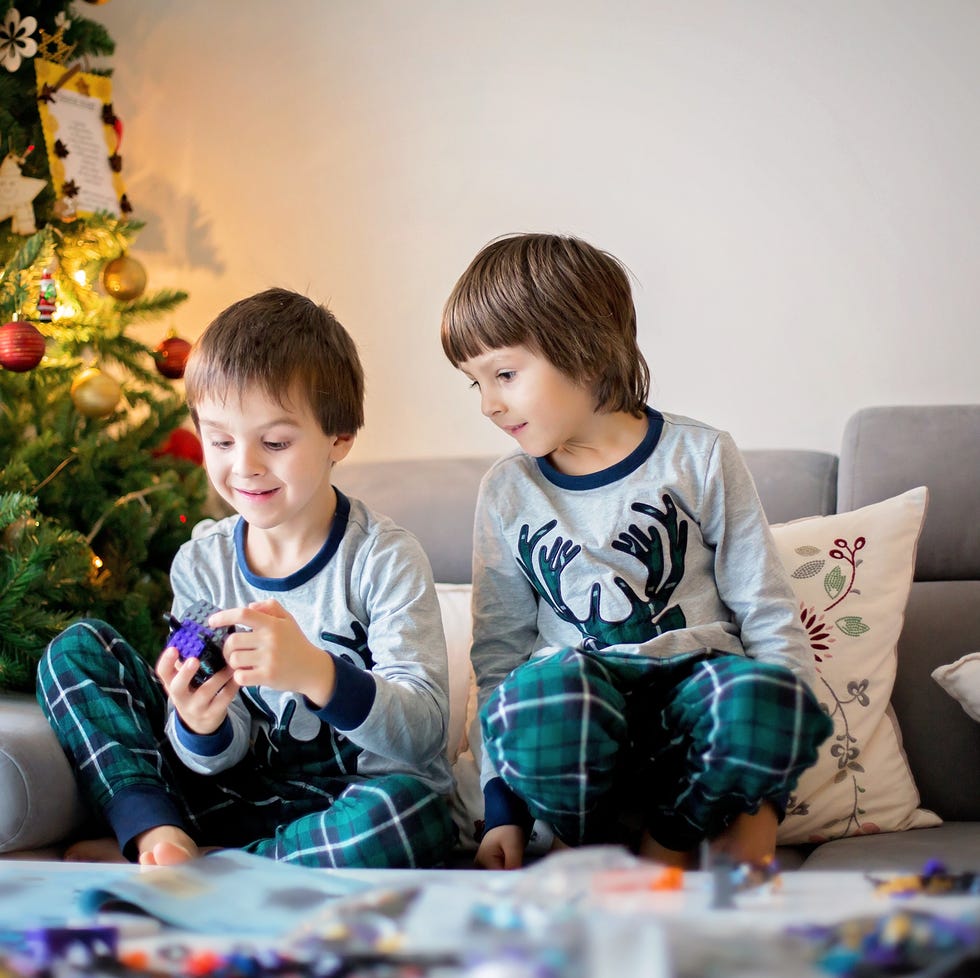 preschool children, boy brothers, playing together with colorful blocks, building different toys