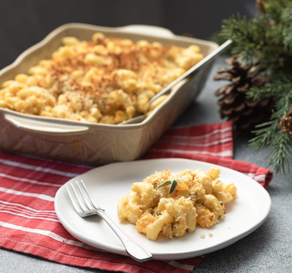 baked macaroni and cheese served on a plate with a side dish in a baking dish