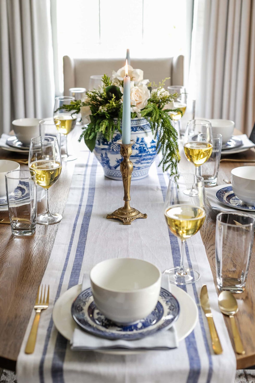 a table with a candle and glasses of wine on it