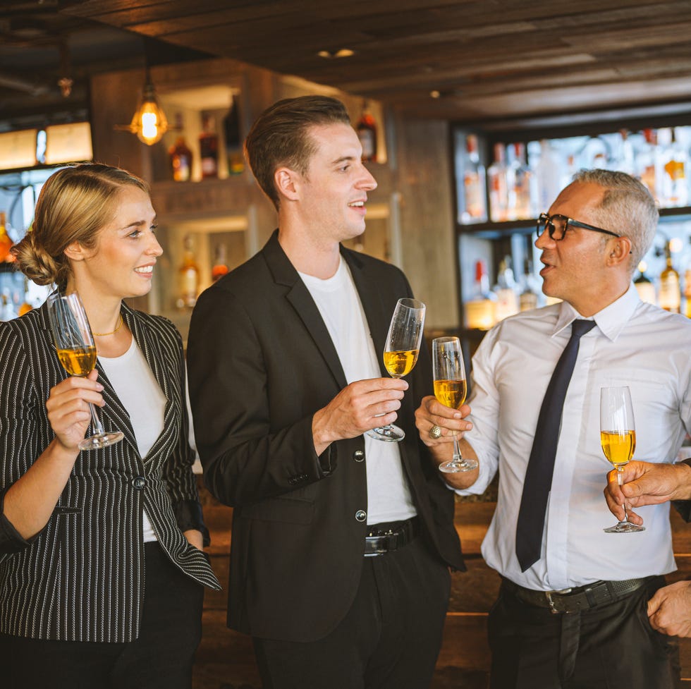 business people having fun talking and discussion with while drinking champagne at business success party