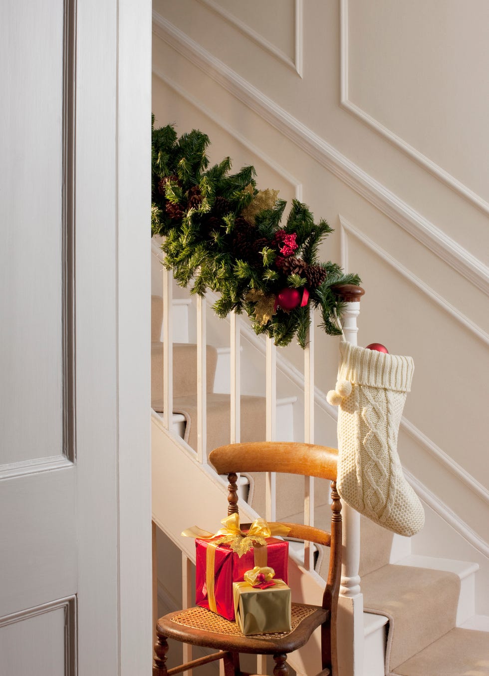 christmas-gifts-and-stocking-near-staircase-royalty-free-image-1730910615