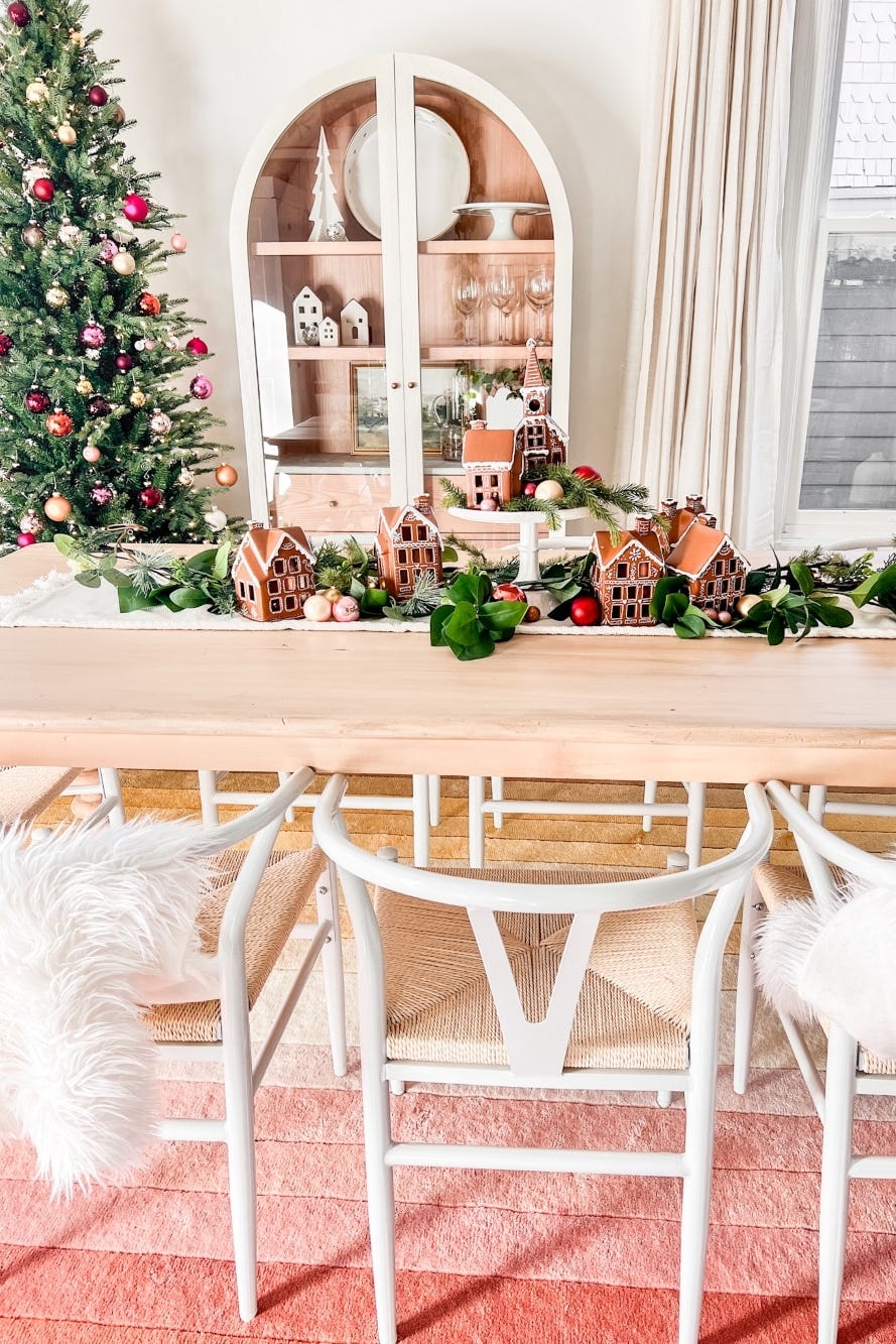 decorated dining space with a christmas tree and gingerbread houses