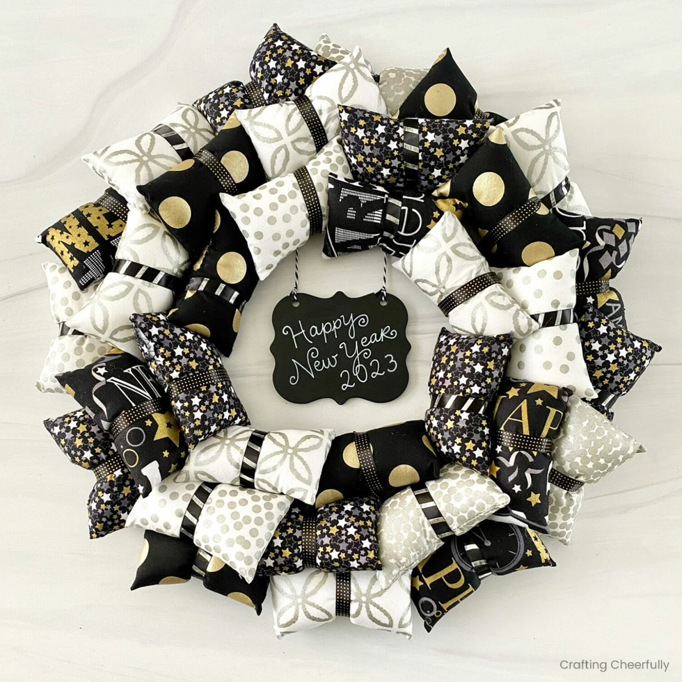 a black gold and white pillow wreath