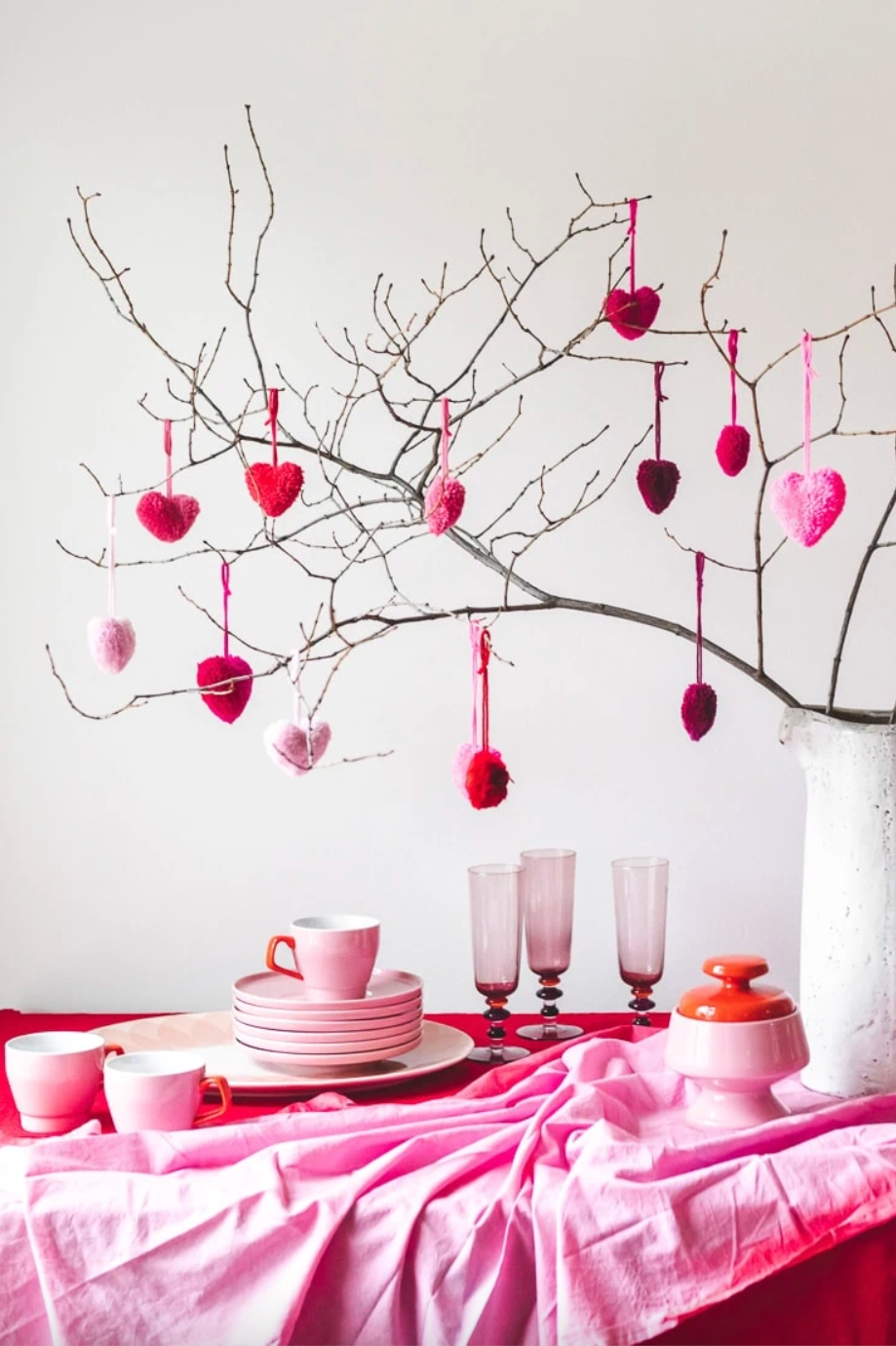 a table with a pink tablecloth and glasses with a pink tablecloth