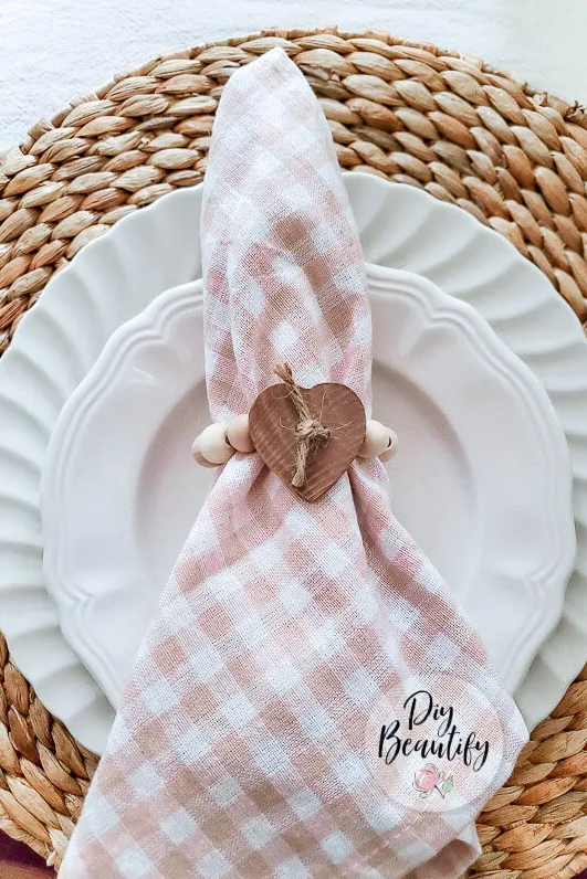 napkin arranged on a plate with a heart ring